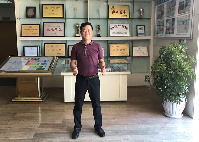 台湾榴莲视频官网万里扬荣誉证书前留念